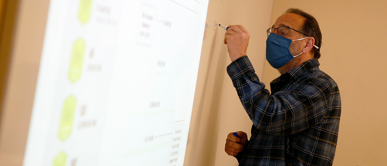 Professor working with students during lesson