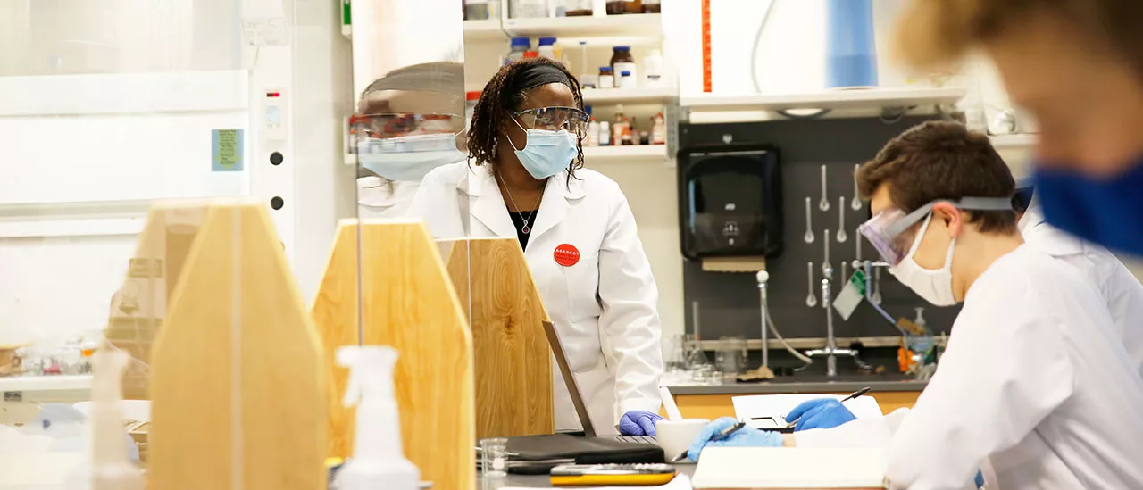 Professor working with students to test different materials.