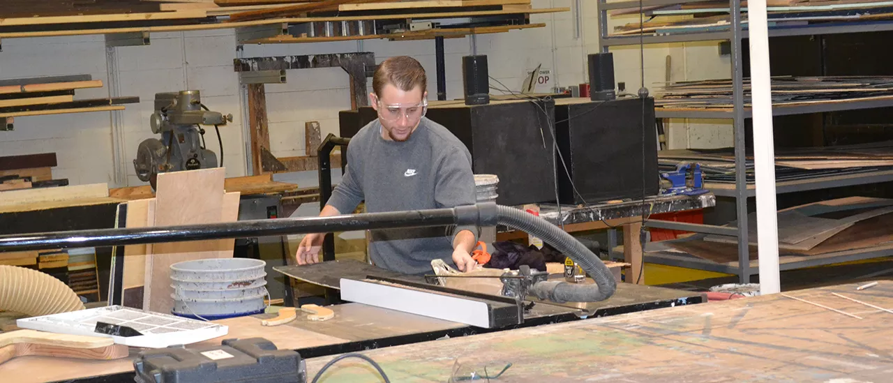 A student works in the scene shop at SUNY Oneonta