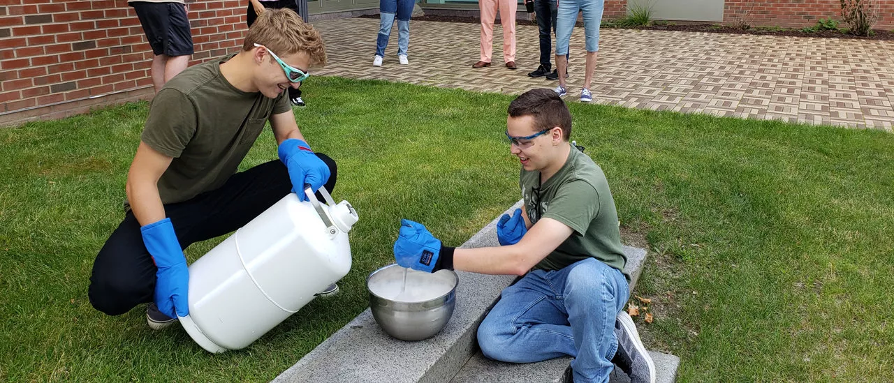 Jacob and Derek make some liquid nitrogen ice cream during a team lunch break.