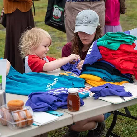 Child being assisted at the Farmers Market