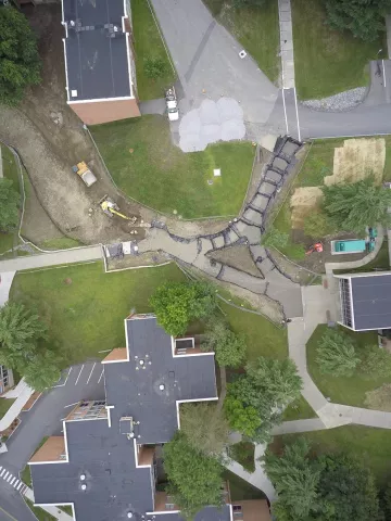 The bedding is assembled in a series of stepped segments filled with crushed stone and embedded piping. This is the area right next to Wilsbach.