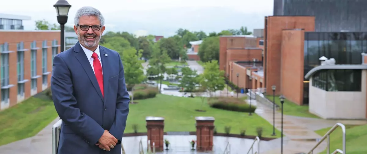 President Cardelle standing in front of the Quad.