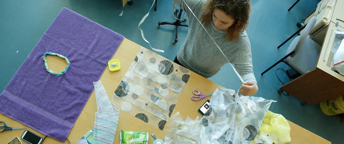 Fashion student measuring pieces of fabric