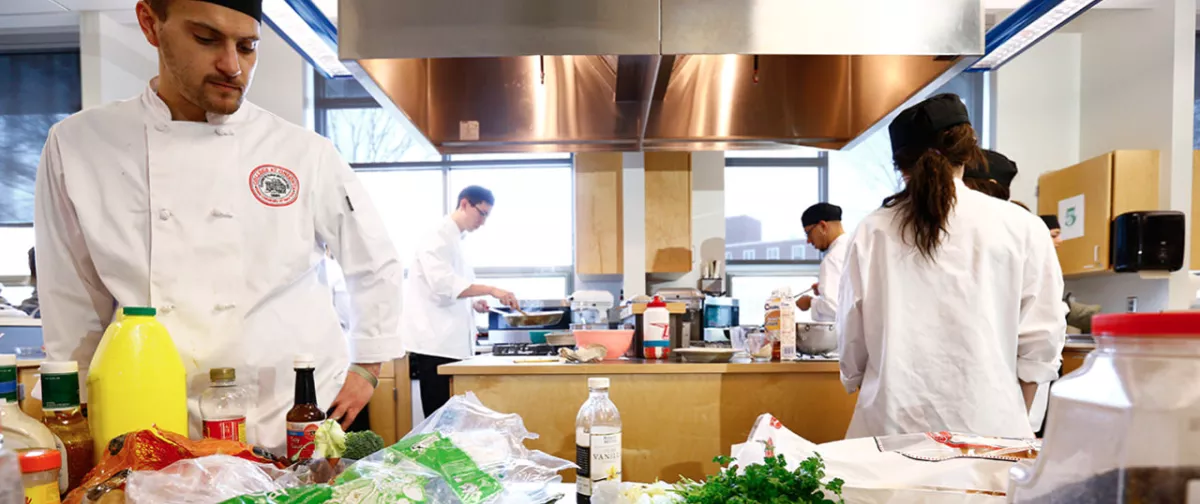 Students preparing food as part of a iron chef like competition.