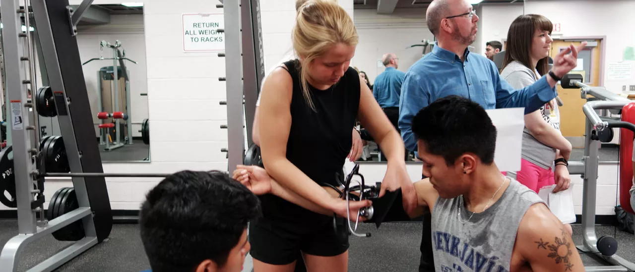 Exercise Science Student measuring another student's blood pressure.