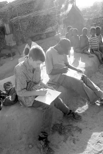 AISB students paint under the watchful eye of village children.