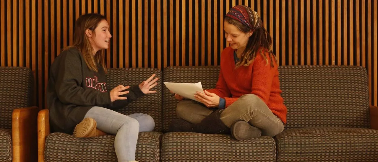 Faculty member reviews paper with student