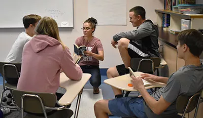 Jenna in the classroom reading to students