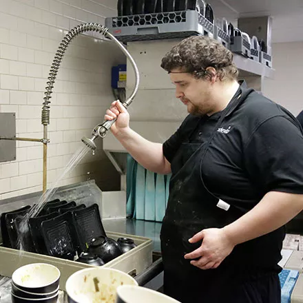 Devyn Servo prepares dishes for the washer