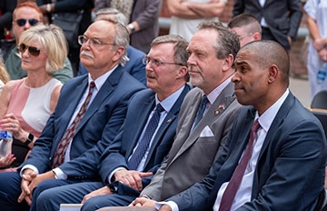 Excl Center Ribbon Cutting Elected Officials Listening to Dr Cardelle