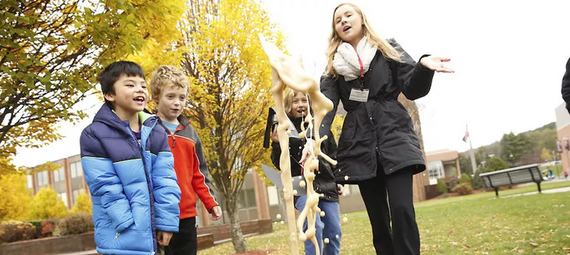SUNY Oneonta student working with children outdoors