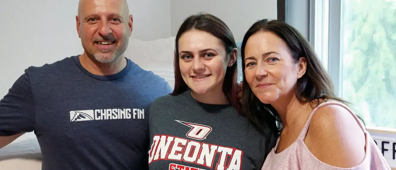 Mother and father helping their daughter move into her new dorm.