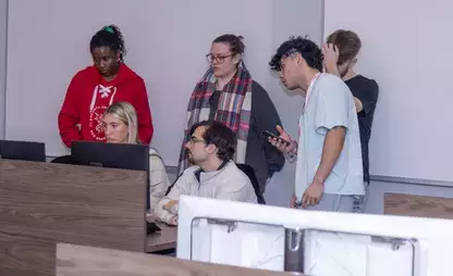 Members of the Accounting Society look over a member's work.