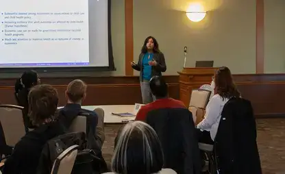 Speaker Pinka Chatterji, Ph.D., discussing economics and maternal health.