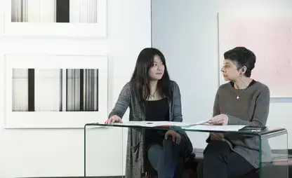 Kathy Spitzhoff, assistant professor of graphic design at SUNY Oneonta, advises studio art major Briela Tollisen.