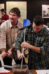 Professor Tracey Allen helping students in class.