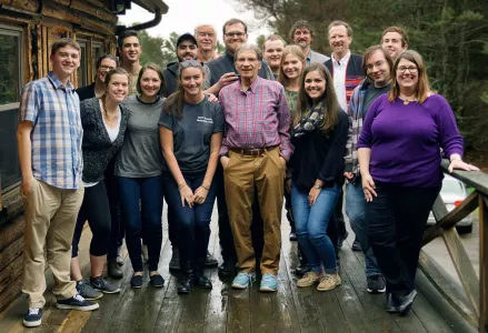 Geography senior students posing at a lodge.