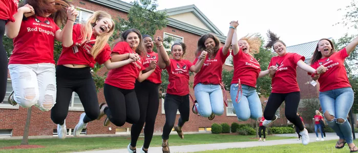 Geography students jumping in the air.