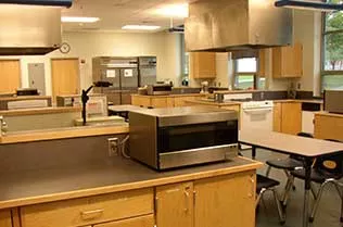 The student kitchen with lots of tables.