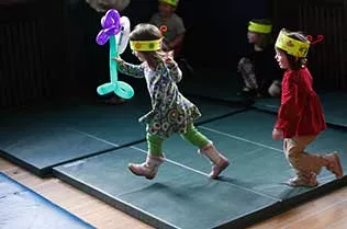 Children playing with balloon animals.