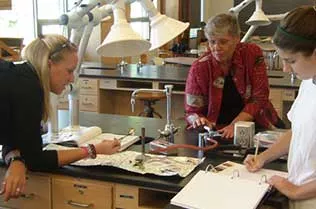 Students examining different types of cloth.