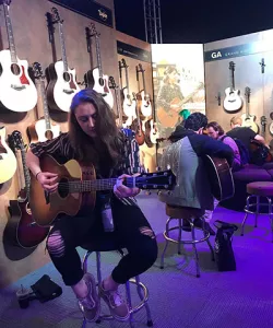 Oneonta student Fiona Perosi tries out a guitar