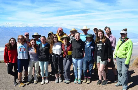 Students and faculty posing in front of the Bad Lands