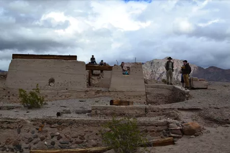 Students exploring a primitive dwelling in the Bad Lands