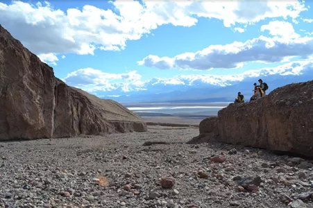 Students sitting on a cliff enjoying the view of the Bad Lands