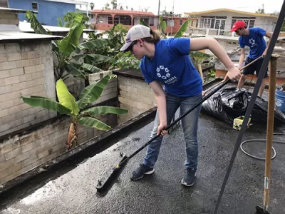 Student volunteers fixing a roof in Puerto Rico.