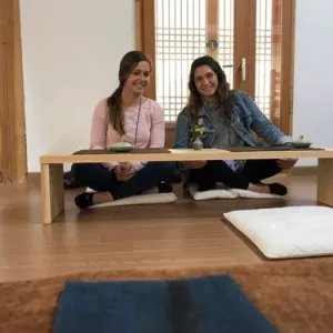 Students enjoying tea in a traditional South Korean home.